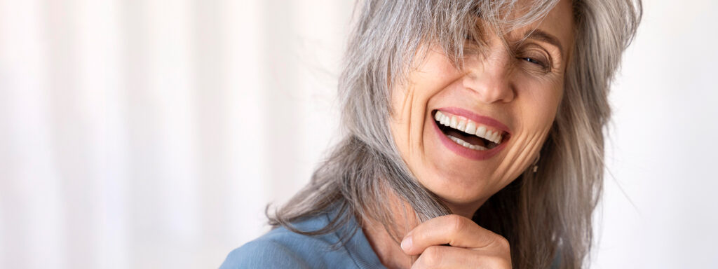 Older woman with a warm, confident smile