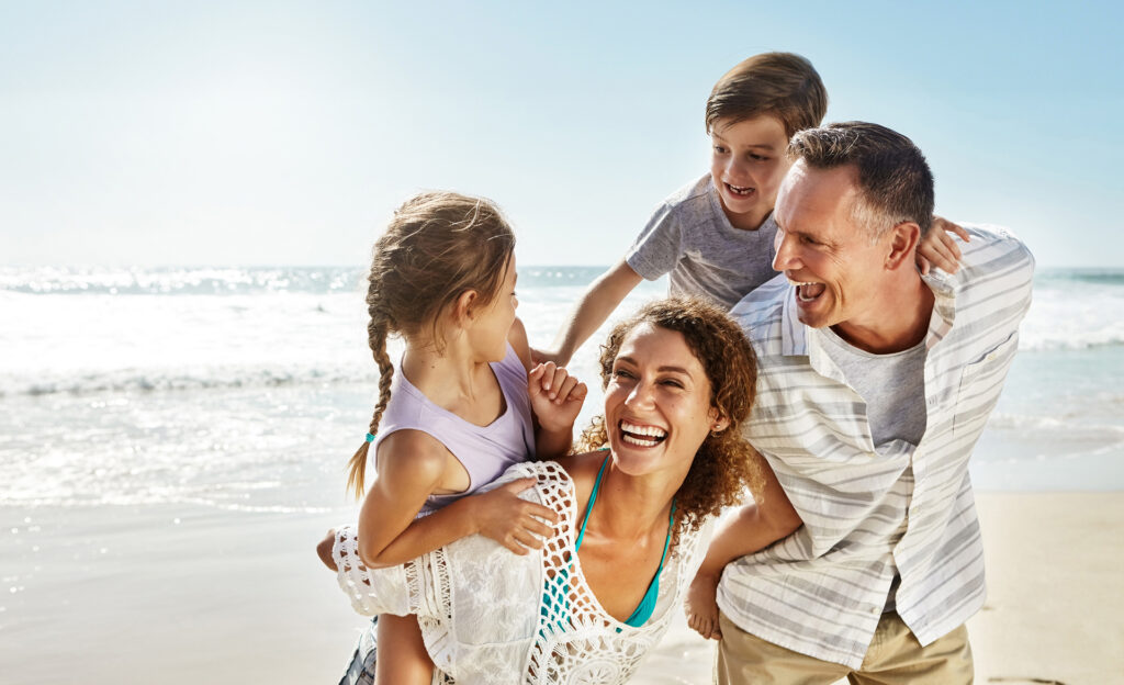 Happy family laughing together with healthy smiles