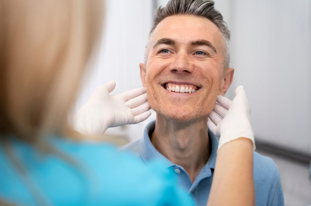 Dental Implants in Carrollwood, FL | Placed & Restored In-House 2 checking man smile